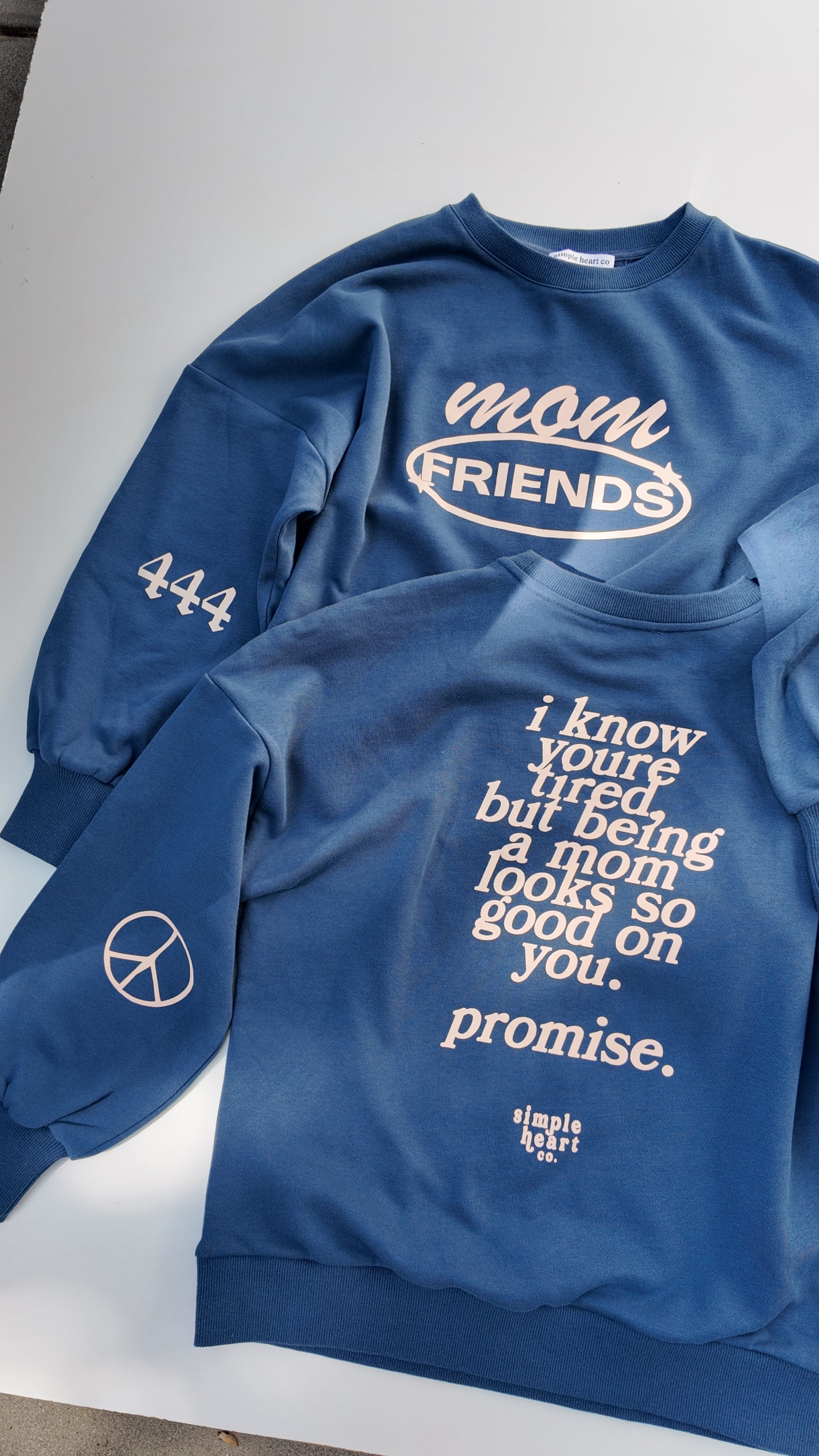Back view of blue mom sweatshirt with uplifting motherhood message: being a mom looks so good on you.