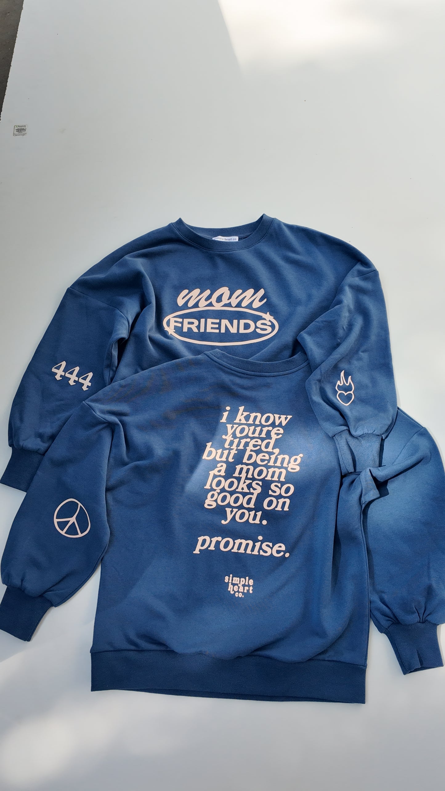 Back view of blue mom sweatshirt with uplifting motherhood message: being a mom looks so good on you.