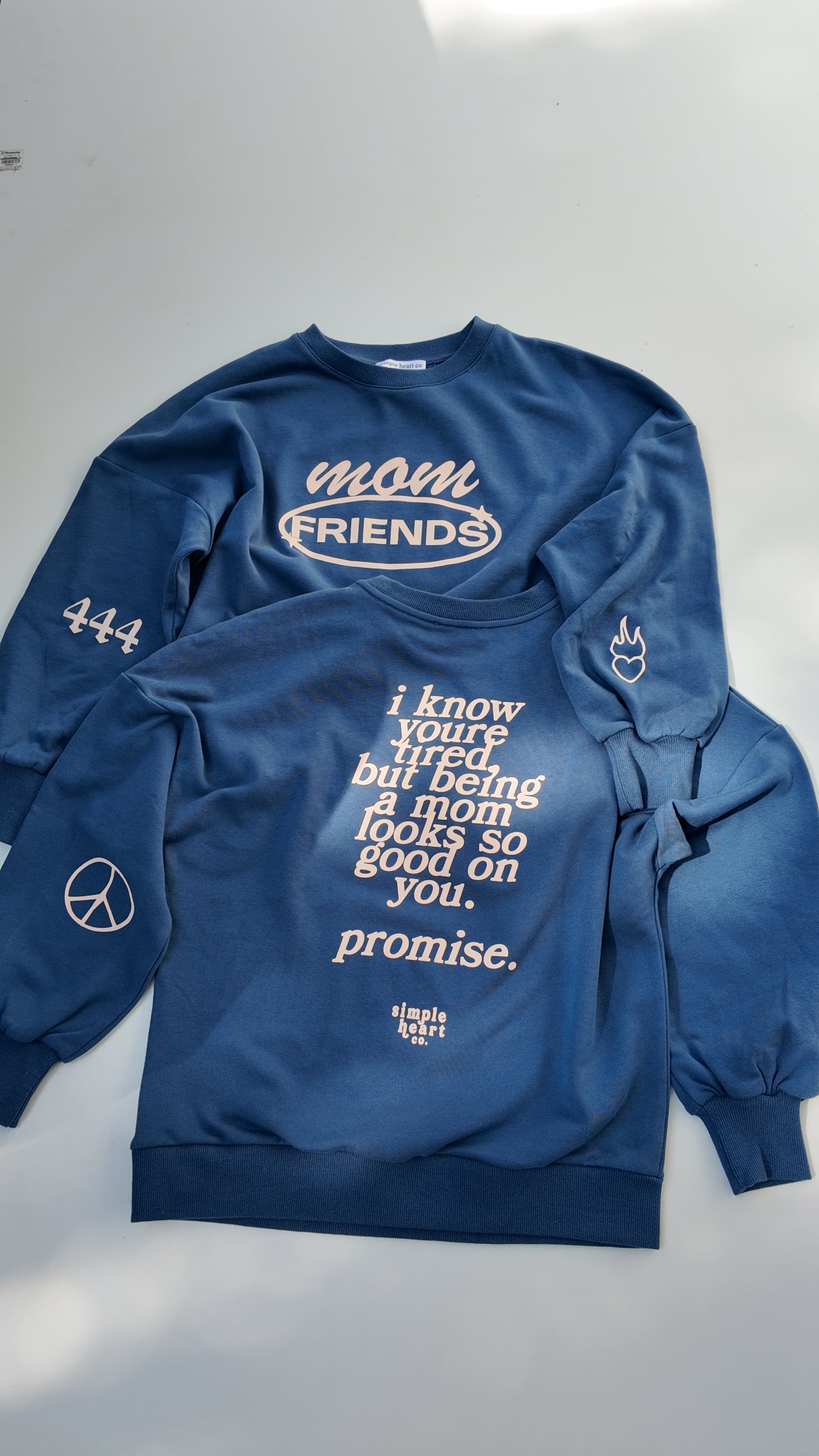 Back view of blue mom sweatshirt with uplifting motherhood message: being a mom looks so good on you.
