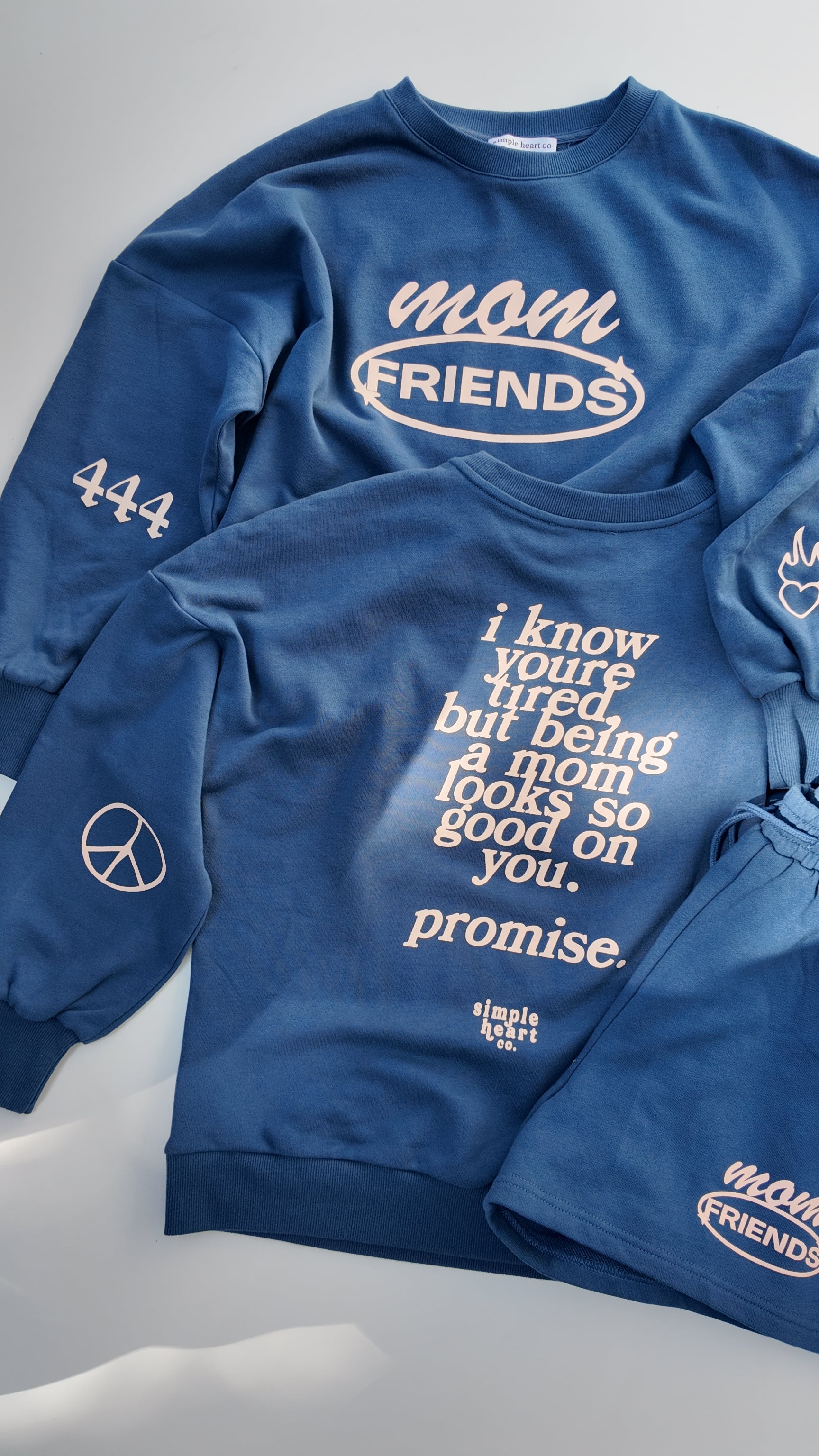 Back view of blue mom sweatshirt with uplifting motherhood message: being a mom looks so good on you.